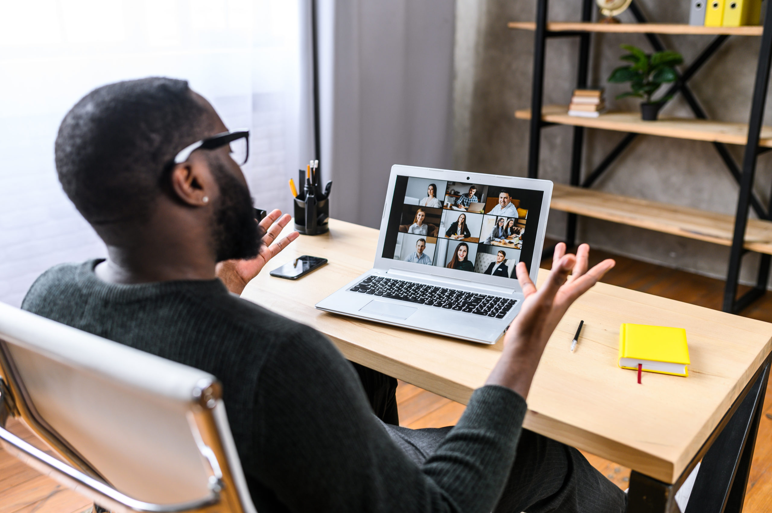 man video conferencing with his colleagues, an EHS trend likely to continue into 2021